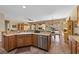 Bright kitchen featuring stainless steel appliances, a breakfast bar, and views of the backyard at 2467 Moonlight Valley Ave, Henderson, NV 89044