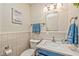 Bathroom featuring a new toilet and vanity, modern fixtures, and tiled walls at 2825 E Hacienda Ave, Las Vegas, NV 89120