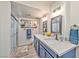 Modern bathroom featuring double sinks, quartz countertops, new fixtures, and a walk-in glass shower at 2825 E Hacienda Ave, Las Vegas, NV 89120