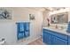 Bright bathroom with blue vanity, quartz countertops, and marine-themed decor at 2825 E Hacienda Ave, Las Vegas, NV 89120