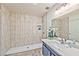 Modern bathroom featuring a beautifully tiled shower, neutral countertops, and contemporary fixtures at 2825 E Hacienda Ave, Las Vegas, NV 89120