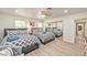 Bright bedroom featuring two beds, ceiling fan, light wood floors, and closet with mirrored sliding doors at 2825 E Hacienda Ave, Las Vegas, NV 89120