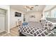 Bedroom with a bay window, ceiling fan, and large TV; light wood floors and a modern dresser at 2825 E Hacienda Ave, Las Vegas, NV 89120