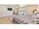 Bright bedroom with light wood flooring, a ceiling fan, and sliding glass door to the outside patio at 2825 E Hacienda Ave, Las Vegas, NV 89120