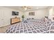 Bright bedroom features light floors, a TV, and two beds with fresh linens in a neutral palette at 2825 E Hacienda Ave, Las Vegas, NV 89120