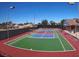 Well-maintained tennis court surrounded by fencing and lighting, with a building in the background at 2825 E Hacienda Ave, Las Vegas, NV 89120