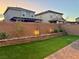 Well-maintained backyard with green lawn, brick planter, and privacy wall at 2829 Mozia Ct, Henderson, NV 89044