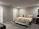 Comfortable bedroom with neutral walls, plush carpeting, a queen-sized bed with decorative bedding, and modern decor at 2829 Mozia Ct, Henderson, NV 89044