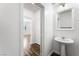 Bathroom with pedestal sink, mirror and neutral decor at 2894 Via Firenze, Henderson, NV 89044