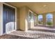 Covered entryway featuring a solid front door, brick flooring and arched openings with a desert view at 2894 Via Firenze, Henderson, NV 89044