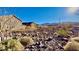 Desert landscape view showcasing neighboring homes and a mountain range against a blue sky at 2894 Via Firenze, Henderson, NV 89044