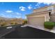 Spacious two-car garage with extended driveway and desert landscaping at 2894 Via Firenze, Henderson, NV 89044