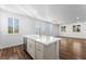 Bright kitchen featuring an island with a sink, white cabinetry and ample counter space at 2894 Via Firenze, Henderson, NV 89044