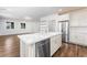 Bright kitchen featuring an island, stainless steel appliances, and open shelving at 2894 Via Firenze, Henderson, NV 89044