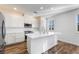 Modern kitchen with white cabinets, stainless steel appliances, and a large central island at 2894 Via Firenze, Henderson, NV 89044