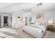 Staged main bedroom with ceiling fan, ensuite, and neutral decor at 2894 Via Firenze, Henderson, NV 89044