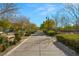 Community walkway lined with benches and mature trees providing shade at 2894 Via Firenze, Henderson, NV 89044