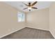 This bedroom features neutral walls, carpet, a ceiling fan, and a window with shutters at 3064 Bicentennial Pkwy, Henderson, NV 89044