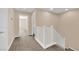 Hallway with neutral carpeting and white railings that leads to other rooms in the home at 3064 Bicentennial Pkwy, Henderson, NV 89044