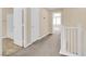 Hallway with a carpet, white doors, and white railings creating a bright and airy space at 3064 Bicentennial Pkwy, Henderson, NV 89044