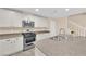 Kitchen featuring granite countertops, stainless steel appliances, white cabinets, and a gas range at 3064 Bicentennial Pkwy, Henderson, NV 89044