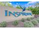 A view of the Inspirada community sign showcasing lush greenery and blue accents at 3064 Bicentennial Pkwy, Henderson, NV 89044