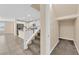 Open-concept staircase leading to a living area with a kitchen featuring stainless steel appliances at 3064 Bicentennial Pkwy, Henderson, NV 89044