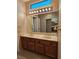 Bathroom featuring double sink vanity with granite counters, framed mirror, and custom lighting at 3104 Archwood Way, Las Vegas, NV 89134