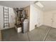 A view of the garage area featuring a water heater, water softener, and a ladder at 3104 Archwood Way, Las Vegas, NV 89134