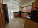 Well-lit kitchen featuring black appliances, dark countertops, and tile flooring at 3104 Archwood Way, Las Vegas, NV 89134