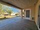 Covered patio area looking out onto a well-manicured backyard with mature trees and landscaping at 3104 Archwood Way, Las Vegas, NV 89134