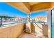 View from the condo balcony looking out over the parking area, with stucco trim and blue sky at 312 Manti Pl, Henderson, NV 89014