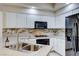 Bright kitchen featuring granite countertops, stainless steel appliances, tile backsplash and white cabinets at 312 Manti Pl, Henderson, NV 89014