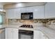 Bright kitchen featuring granite countertops, stainless steel appliances, tile backsplash and white cabinets at 312 Manti Pl, Henderson, NV 89014