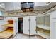 Bright kitchen featuring granite countertops, stainless steel appliances, tile backsplash, roll-out shelving, and white cabinets at 312 Manti Pl, Henderson, NV 89014