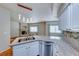 Bright kitchen with granite countertops, stainless steel appliances, tile backsplash, and hardwood flooring at 312 Manti Pl, Henderson, NV 89014