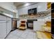 Bright kitchen featuring granite countertops, stainless steel appliances, tile backsplash, roll-out shelving, and white cabinets at 312 Manti Pl, Henderson, NV 89014