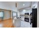 Bright kitchen featuring white cabinetry, granite countertops, stainless steel appliances, and tile flooring at 312 Manti Pl, Henderson, NV 89014