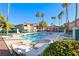 Community pool with lounge seating, palm trees, and building exteriors in the background at 312 Manti Pl, Henderson, NV 89014