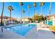 View of the community pool featuring palm trees, jacuzzi and lounge seating in a fenced enclosure at 312 Manti Pl, Henderson, NV 89014