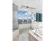 Bright bathroom with marble floors, white cabinetry, and a jacuzzi tub overlooking the city at 322 Karen Ave # 1902, Las Vegas, NV 89109