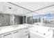 Modern bath with double sink vanity, soaking tub, and separate glass shower with amazing city views at 322 Karen Ave # 1902, Las Vegas, NV 89109