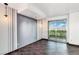 Bright living area with tile floors, modern lighting, an accent wall and sliding door access to balcony at 322 Karen Ave # 1902, Las Vegas, NV 89109