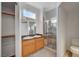 Bathroom with a dual sink vanity, framed mirror, and a glass-enclosed shower at 3705 Covewick Dr, North Las Vegas, NV 89032