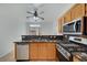 A kitchen featuring stainless steel appliances, a breakfast bar, and granite countertops at 3705 Covewick Dr, North Las Vegas, NV 89032