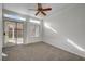 Living room with a ceiling fan and backyard access through sliding glass doors at 3705 Covewick Dr, North Las Vegas, NV 89032