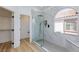 Modern bathroom featuring a glass shower, window, and bench seat at 3957 Genoa Dr, Las Vegas, NV 89141