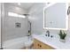 Modern bathroom featuring a tub and light wood vanity with light-up mirror at 3957 Genoa Dr, Las Vegas, NV 89141