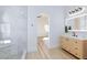 Modern bathroom featuring a marble walk-in shower and light wood vanity at 3957 Genoa Dr, Las Vegas, NV 89141