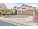 Charming single story home featuring a three car garage and meticulously landscaped front yard with mature desert trees at 3957 Genoa Dr, Las Vegas, NV 89141